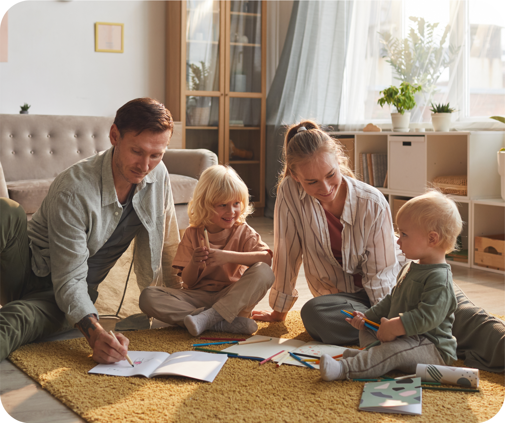 two-parents-drawing-floor-together-with-their-two-children-living-room